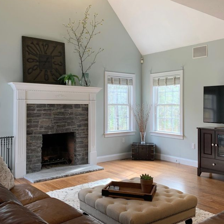 Light blue painted walls in a traditional living room painted Quiet Moments (Benjamin Moore) - @sarahlabrieinteriors. #quietmoments #paintcolors #benjaminmoorequietmoments #paleblue