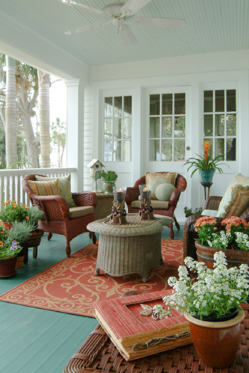 Quiet Moments pale blue paint color (Benjamin Moore) on a porch ceiling in a lovely space with rattan furniture - @islandpainteddecorating. #quietmoments #paintcolors #lightblue #paintcolors