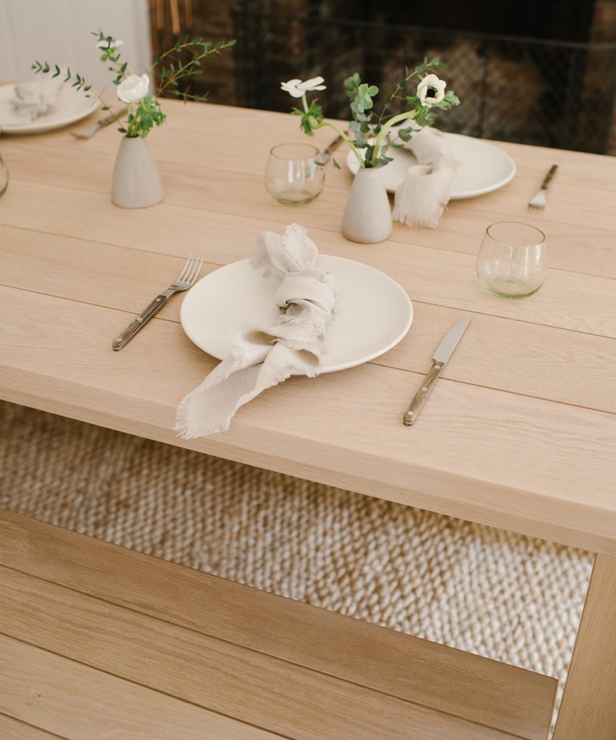Jenni Kayne dining table with minimal styled place settings.