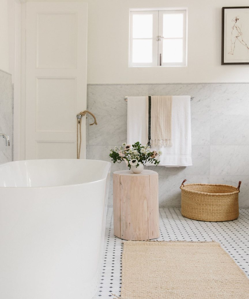 Laid back Cali organic natural luxe bathroom by Jenni Kayne with nesting basket and stump.