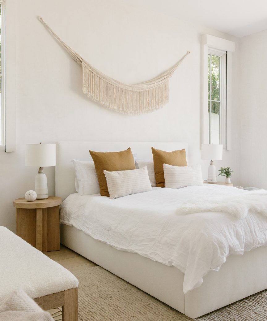 Natural, quiet, subdued mood in a lovely Jenni Kayne bedroom with macrame wall hanging.