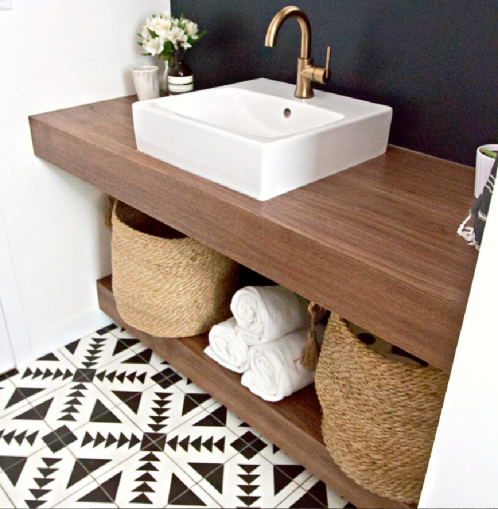 Encaustic tile (Nomads Tile by geontile) in a contemporary bathroom with vessel sink and open storage vanity.