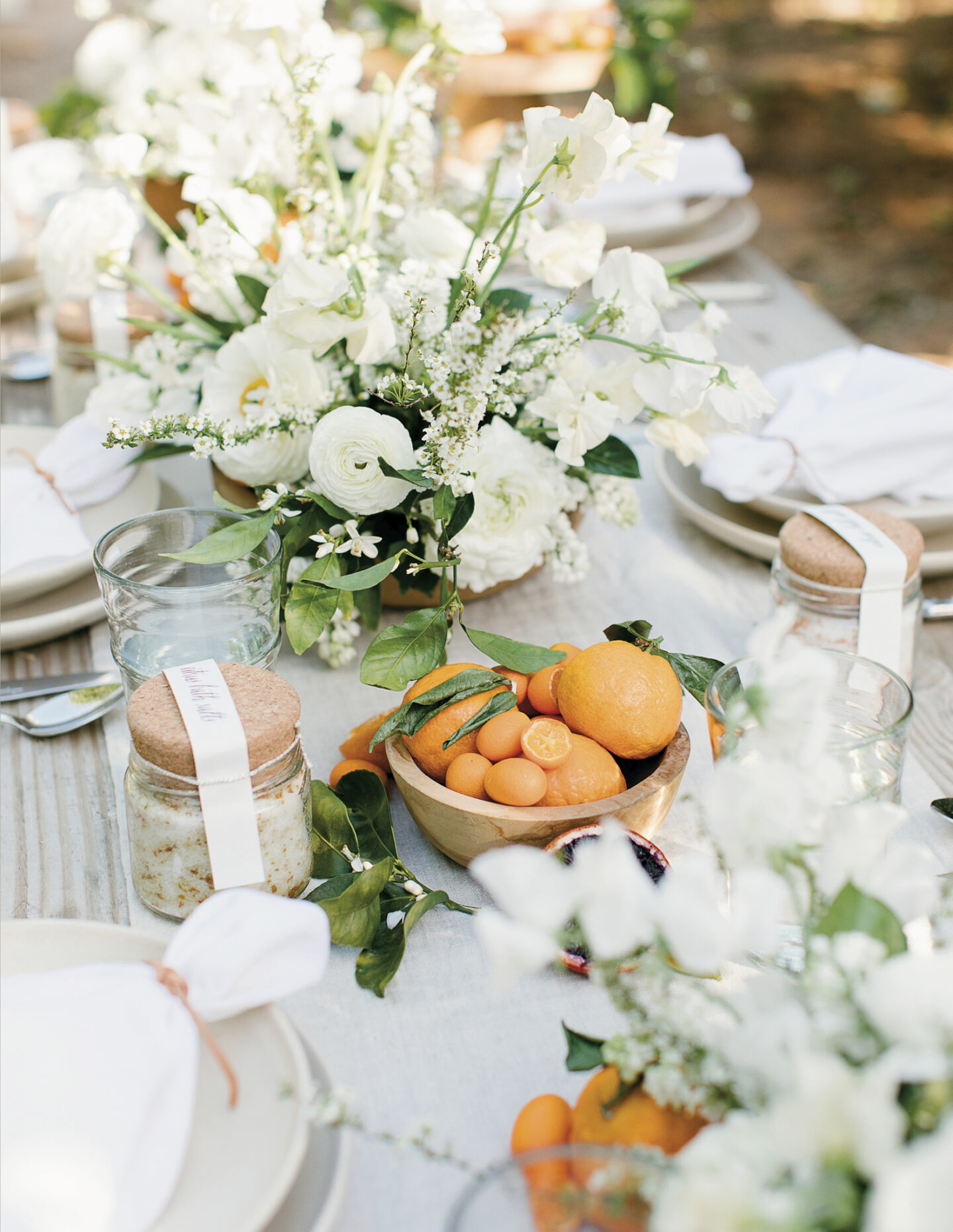 Beautiful outdoor tablescape with earthy organic florals and fruit - Jenni Kayne for PACIFIC NATURAL (Rizzoli, 2019).