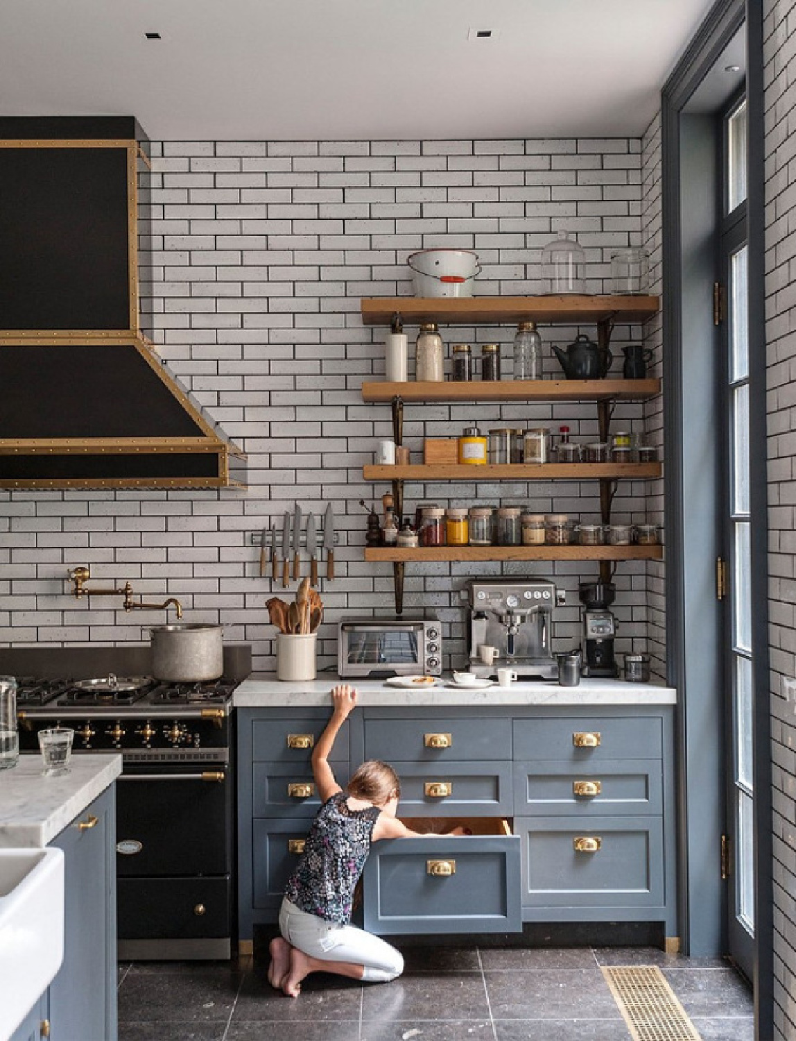 Ali Cayne's SW Gibraltar painted kitchen with black Lacanche range. #bluekitchens