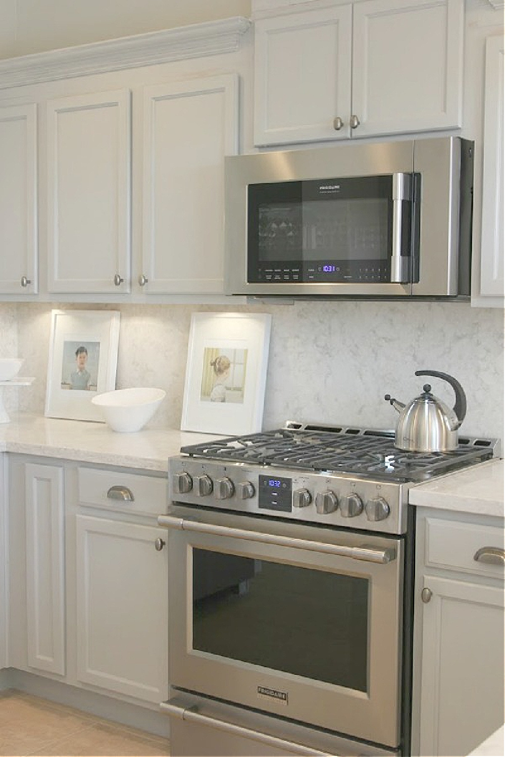 As real life renovators, we made over our ugly Arizona kitchen with no demo or dust with smart upgrades and swaps. Light grey cabinets, Viatera quartz counters (Soprano), and calacatta marble hex accent wall - Hello Lovely studio.