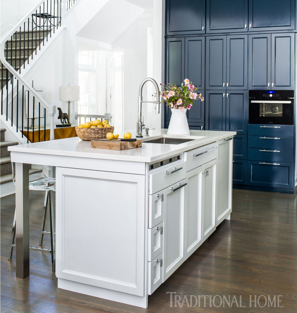 A 12-foot-tall wall of blue cabinetry echoes the backsplash color and allows a black Thermador steam oven to almost disappear. Come see 36 Best Beautiful Blue and White Kitchens to Love! #blueandwhite #bluekitchen #kitchendesign #kitchendecor #decorinspiration #beautifulkitchen
