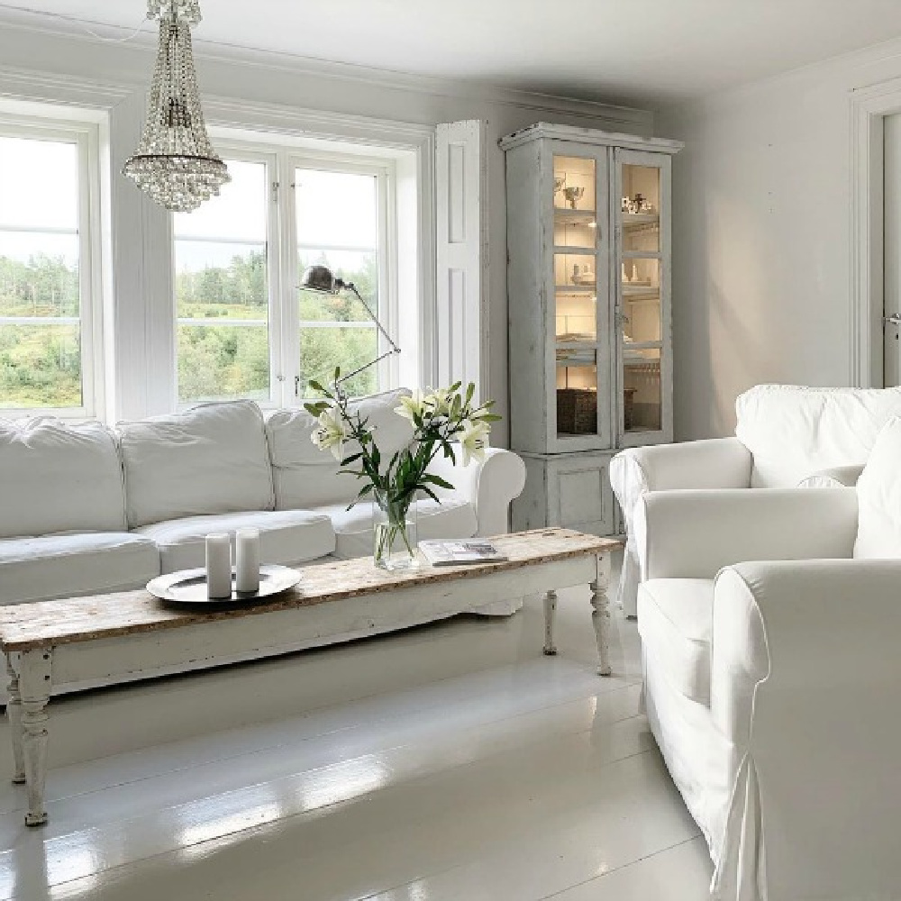 Ethereal, serene, and spare French Nordic white living room by Cathrine Aust. #frenchnordic #livingroom #scandinaviandecor #allwhitedecor #interiordesign