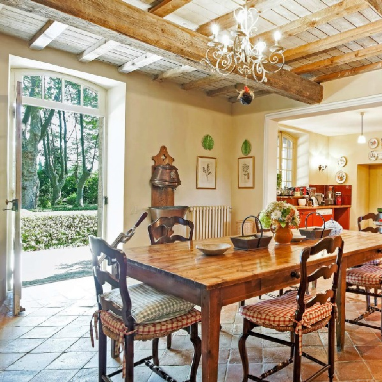 Elegant French kitchen and dining room with wood ceiling and terracotta tiled floors in a breathtaking Provence vacation villa - Haven In.