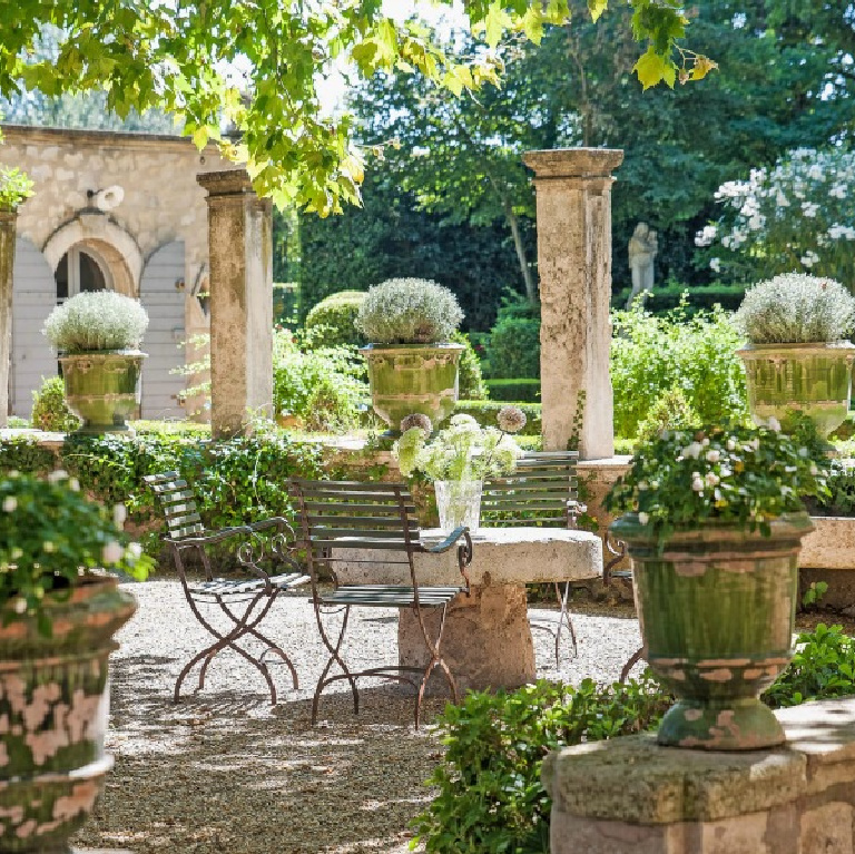 French formal gardens and courtyard with pea gravel - see more of this Stunning French Château Near St-Rémy-de-Provence by Haven In. #frenchgarden #frenchcourtyard #frenchchateau