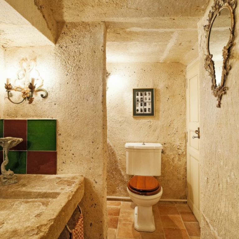 Rustic stone and plaster as well as terracotta floor in an Old World bathroom in a Provence chateau - Haven In.