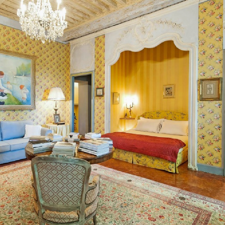 Bright and cheerful traditional style French country colors of blue and yellow in a stunning bedroom with crystal chandelier in a Provence chateau - Haven In.