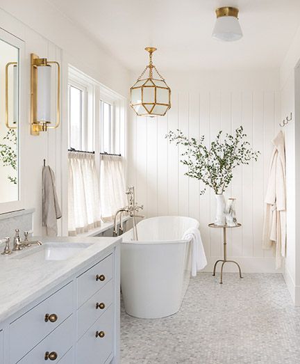 Beautiful classic white bath with freestanding tub - from AT HOME by Brian Paquette (Gibbs Smith, 2021). #bathroomdesign