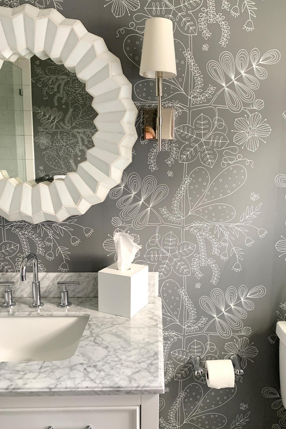 Gorgeous Schumacher grey wallpaper in a powder room with design by Sherry Hart. #interiordesign #powderroom #bathrooms #wallpaper