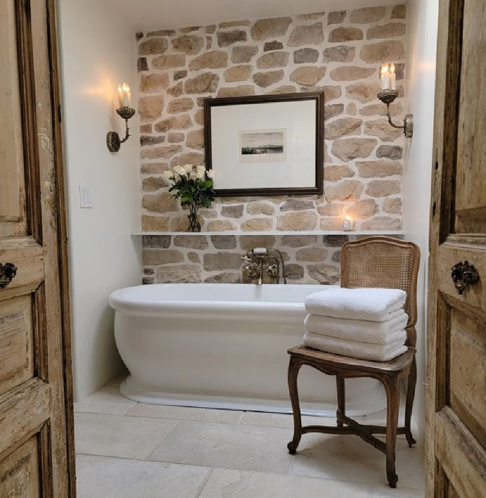 Breathtaking French country bathroom with stone wall - TheFrenchNestCoInteriorDesign. #frenchbathroom #countryfrenchdesign
