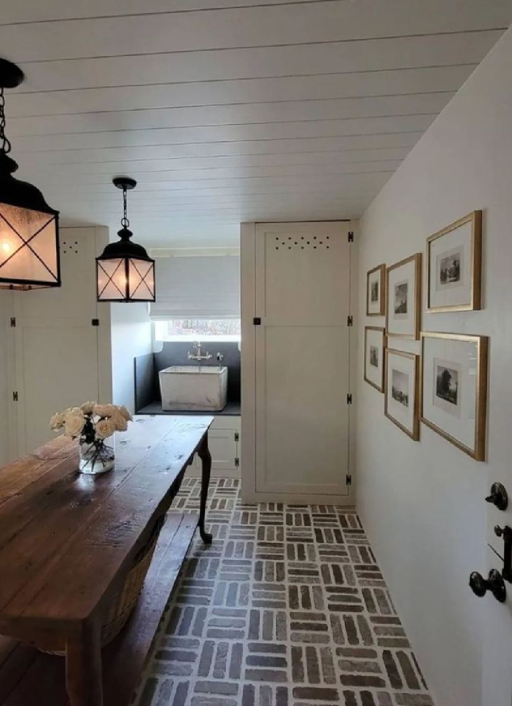 Charming Old World style laundry room with lantern pendants and French country design elements - TheFrenchNestCoInteriorDesign. #laundryrooms #countryfrenchstyle