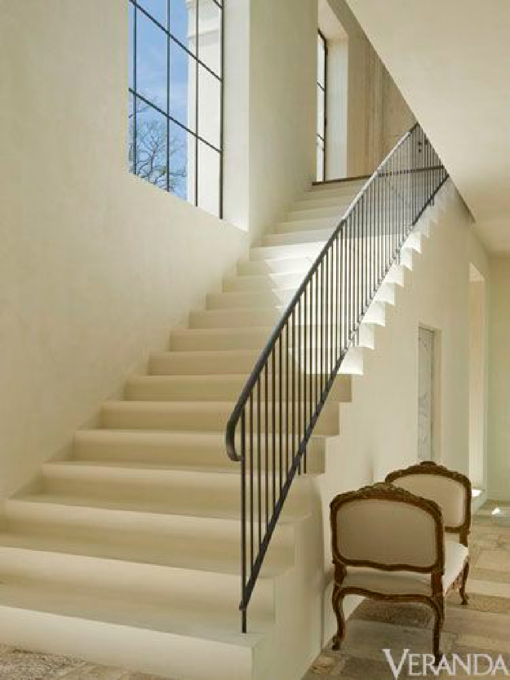 The combination of a simple iron railing with an elegant plaster stair doesn't get any better. It's architecturally beautiful and really makes a statement. Plus, it can work in both traditional and contemporary settings.