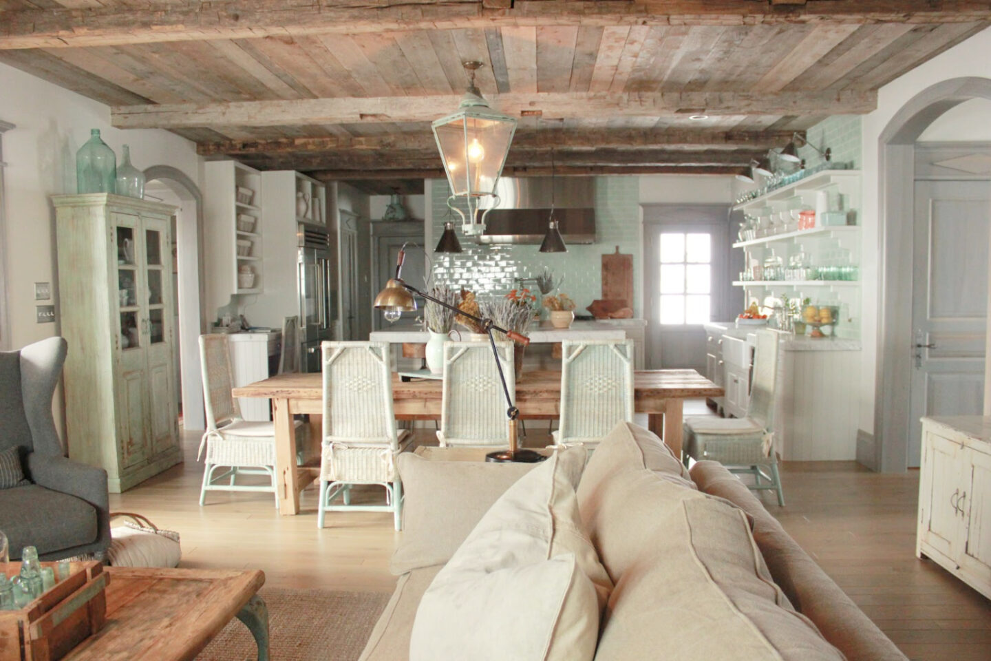 Magnificent Gustavian French stone cottage with rustic interiors, reclaimed wood ceilings, blue-grey, green, and collected European antiques. Designed by Desiree Ashworth. Find ideas for grey, blue, and green paint colors.