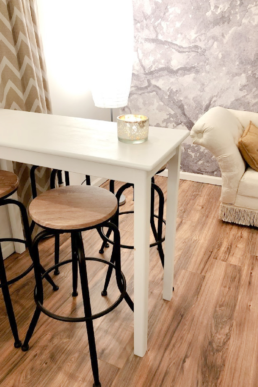 Industrial stools and a counter height table in our finished basement with statement wall (a mural from Photowall!) - come check out the before/after on Hello Lovely.
