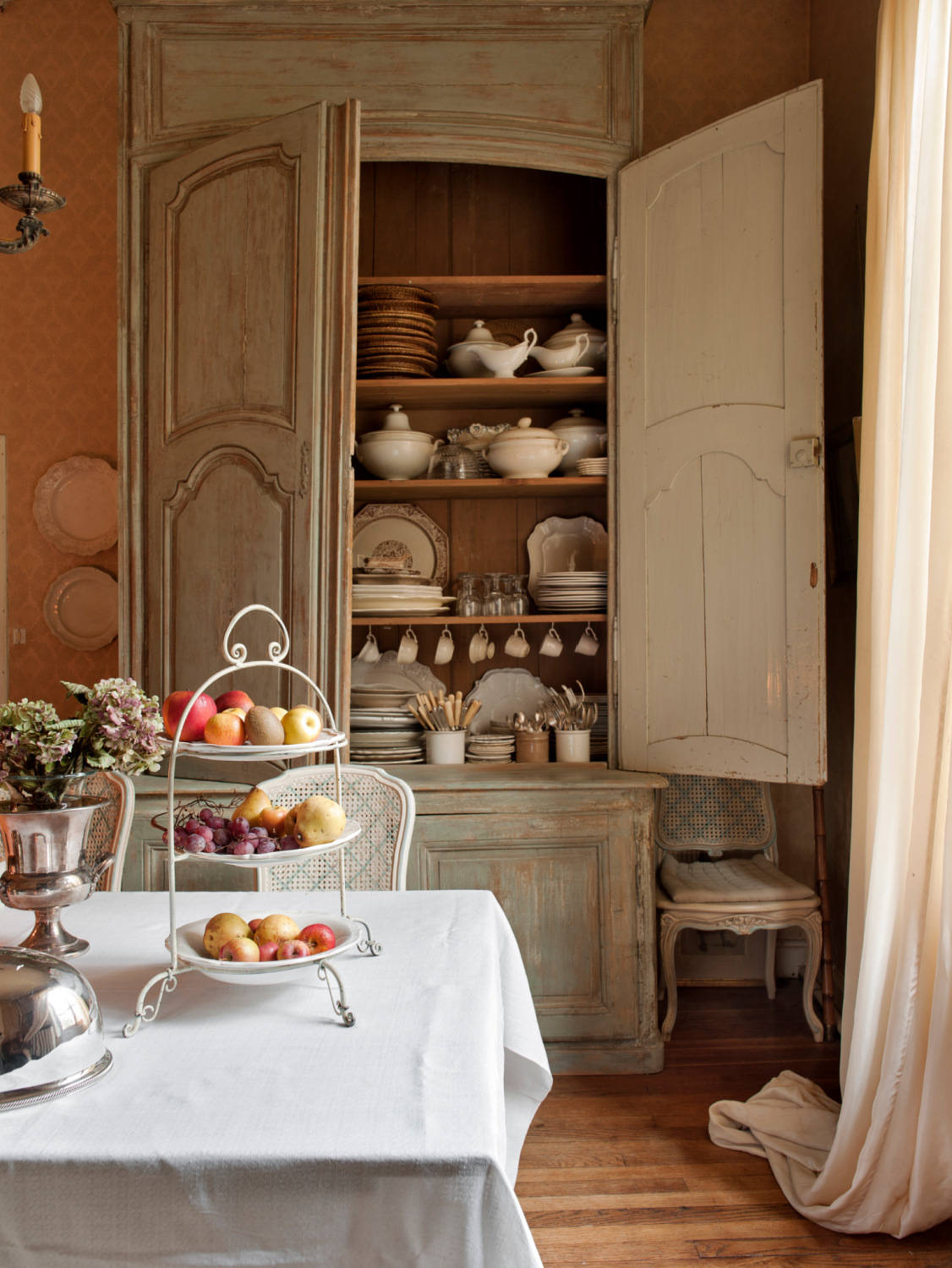 Distressed pale French grey dining room cupboard is full of traditional French provincial style china treasures. Shauna Varvel's PROVENCE STYLE. #interiordesign #frenchcountry #oldworldstyle