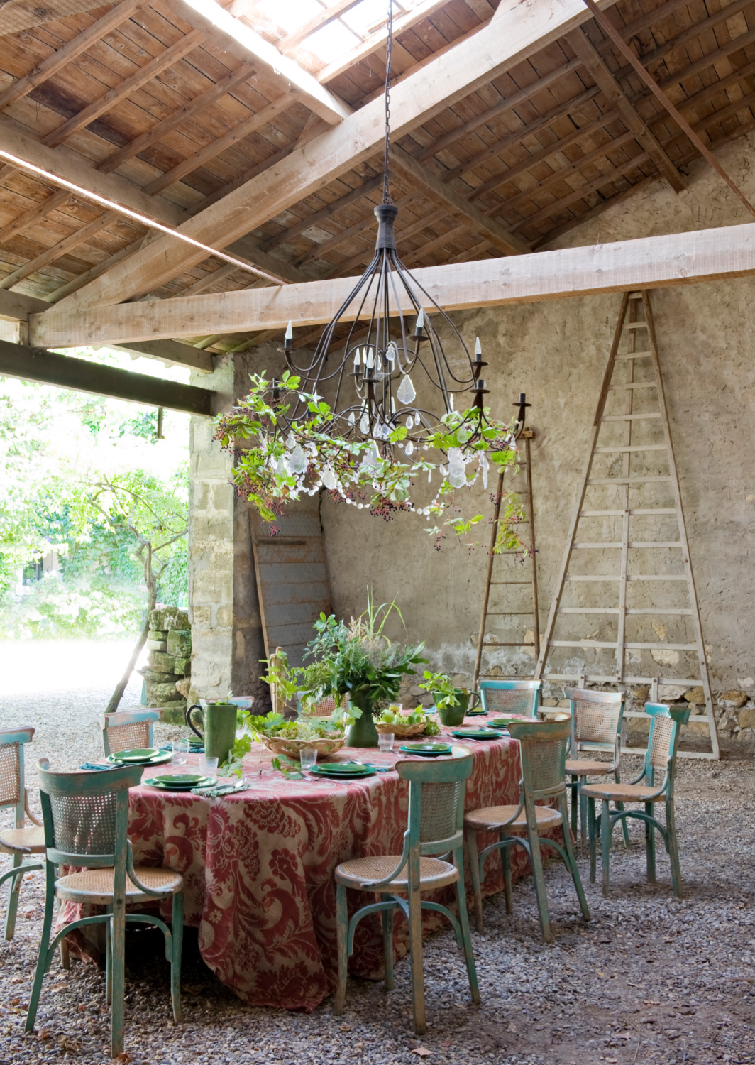 Covered outdoor dining space in Provence with chandelier and rustic wood rafters. Shauna Varvel's PROVENCE STYLE. #frenchproincial #frenchcountry #oldworldstyle