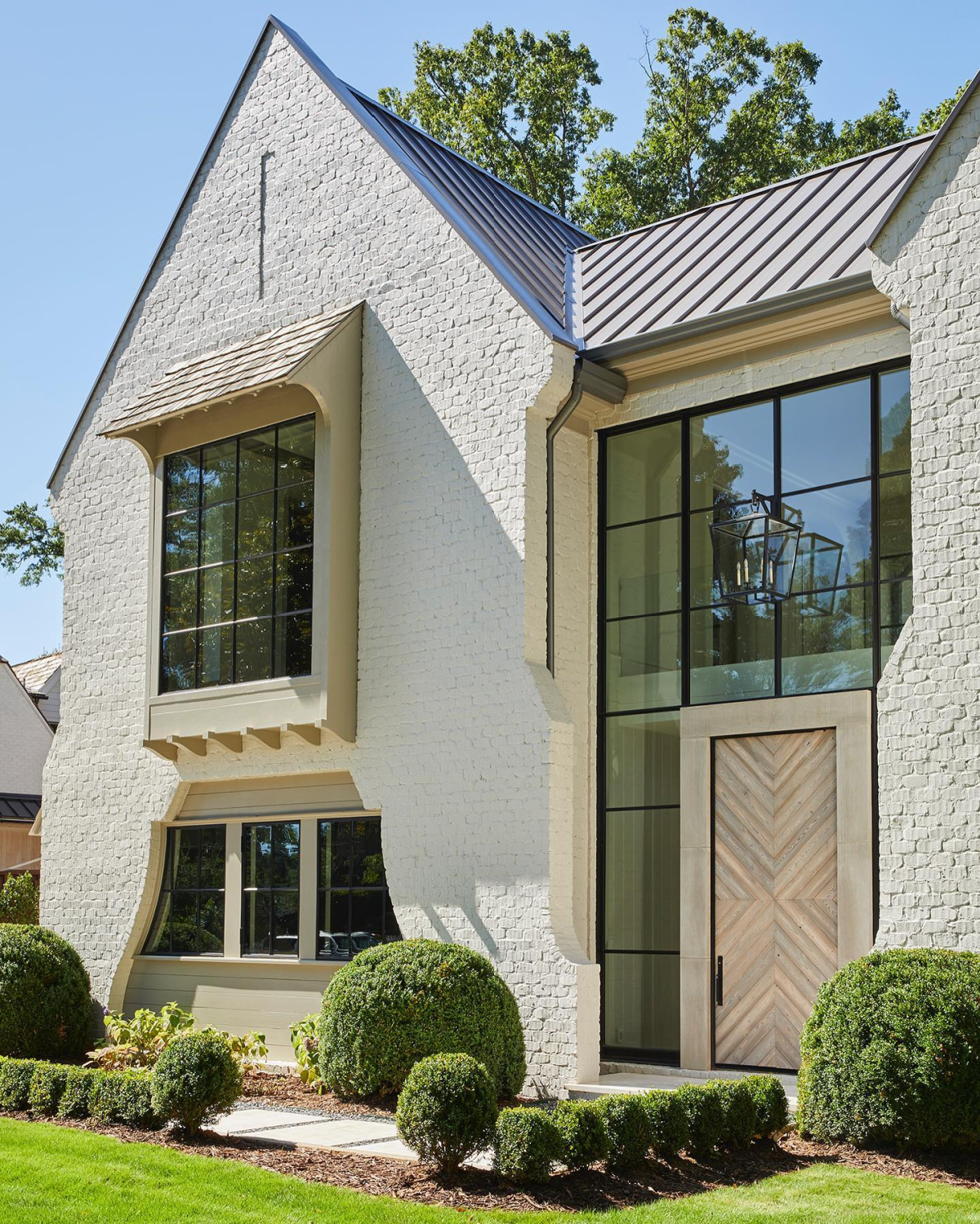 Benjamin Moore Balboa Mist painted brick house exterior - Ladisic Fine Homes & Sherry Hart. #balboamist #intellectualgray #paintcolors #houseexteriors