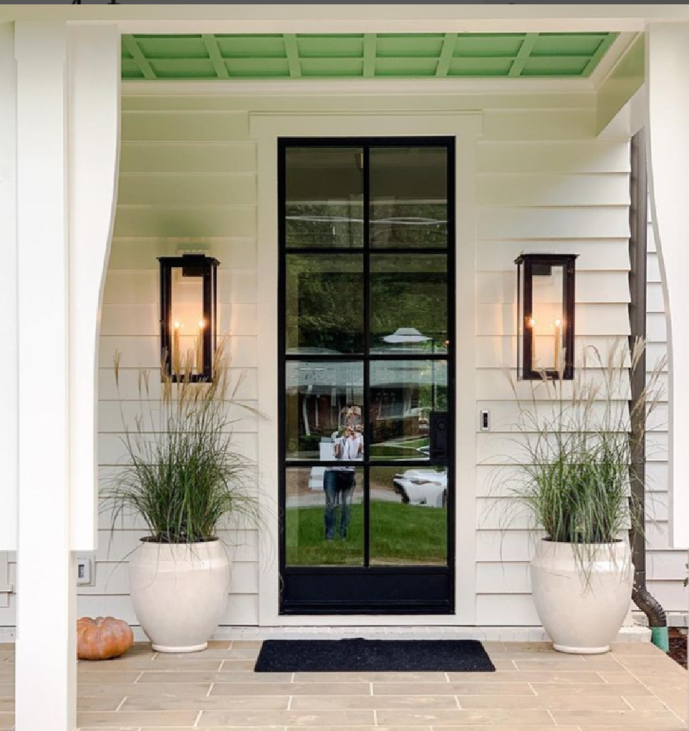 BM China White house exterior with bright green porch ceiling and Bevolo lanterns - Ladisic Fine Homes & Sherry Hart. #paintcolors #whitehouses #chinawhite