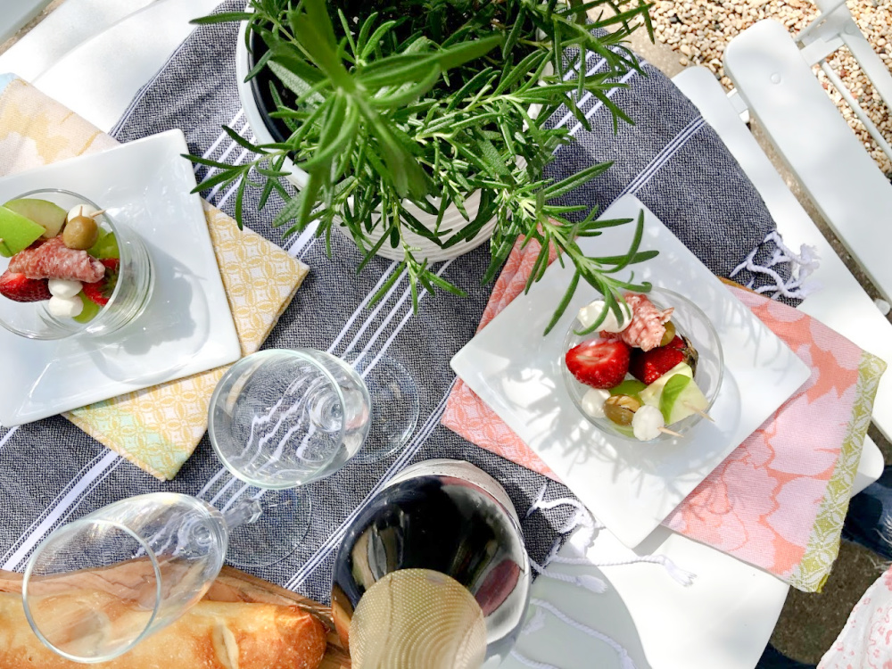 Baguettes, champagne, and simple jarcuterie (cheeseboard in a jar!) for a charming French picnic outside - Hello Lovely Studio.