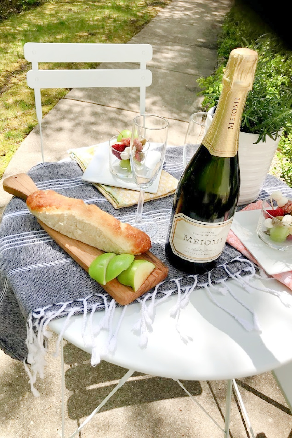 Baguettes, champagne, and simple jarcuterie (cheeseboard in a jar!) for a charming French picnic outside - Hello Lovely Studio.