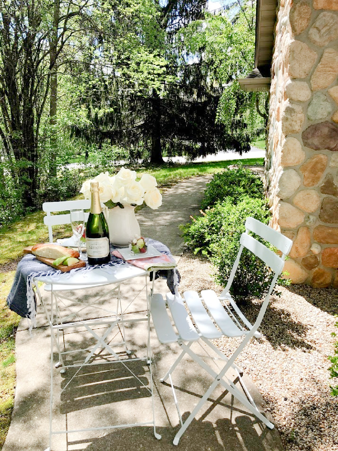 Charmingly French country and rustic casual dining outdoors with white cafe chairs - Hello Lovely Studio. #outdoordining #frenchaesthetic #countryfrench