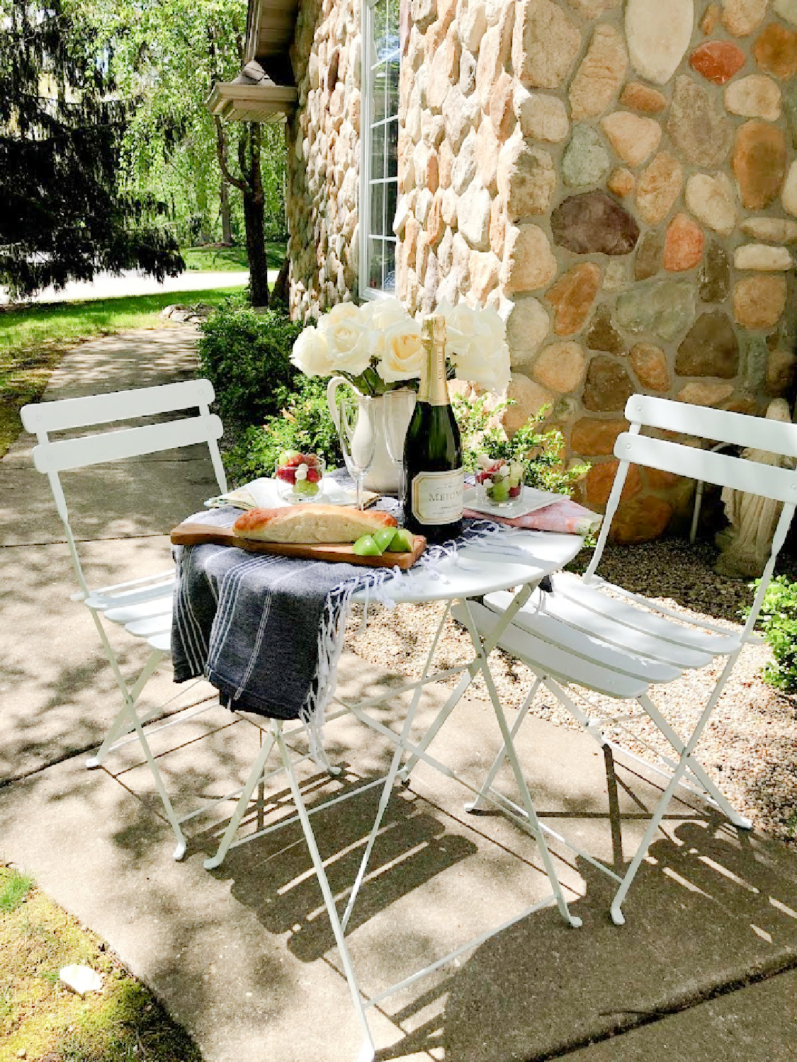 Charmingly French country and rustic casual dining outdoors with white cafe chairs - Hello Lovely Studio. #outdoordining #frenchaesthetic #countryfrench