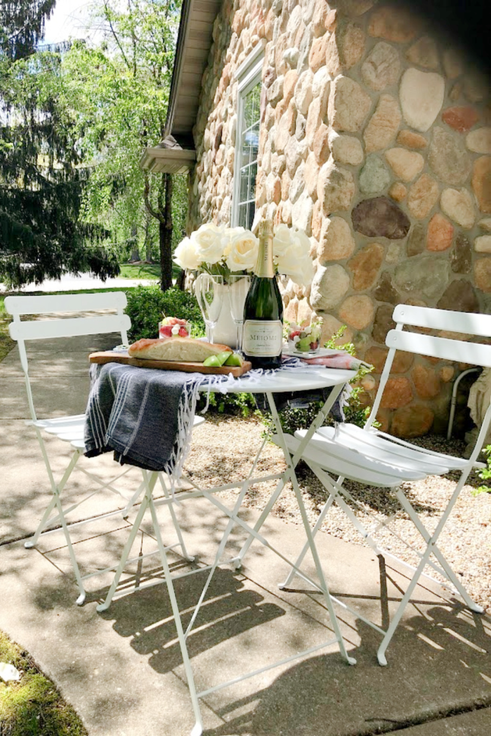 Rustic French country cafe dining in the garden with white roses on the table - Hello Lovely Studio. #frenchcafe #frenchcountry #bistroset #cafeset