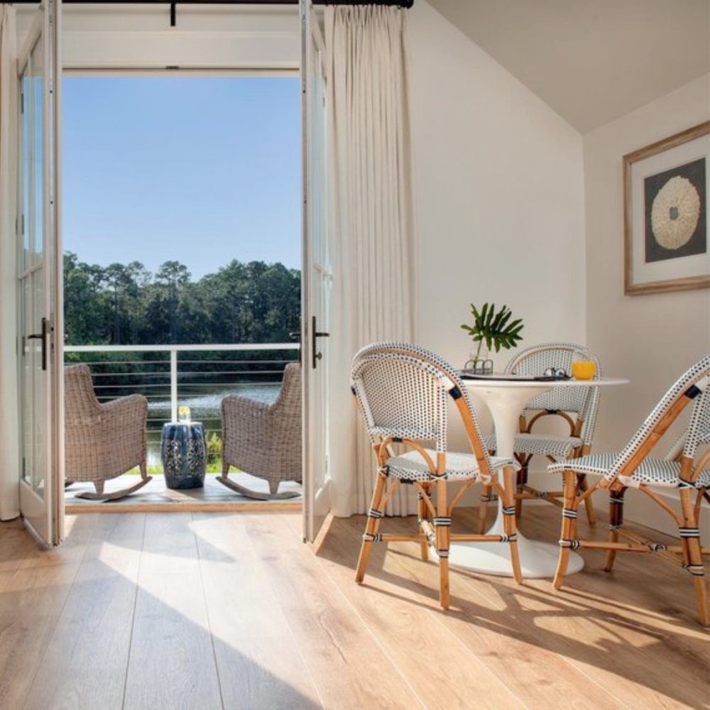 Carriage house bedroom with built in captain beds and French bistro chairs. Board and batten coastal cottage in Palmetto Bluff with modern farmhouse interior design by Lisa Furey. #carriagehouse #bedroom #captainsbeds #coastalstyle #bistrochairs #interiordesign