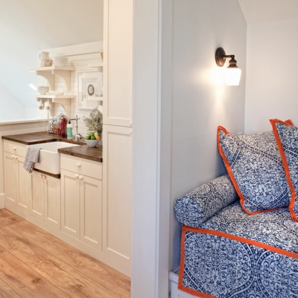 Blue bunk room in carriage house with built in beds, blue and white decor, bistro chairs, and wide plank wood flooring. Design by Lisa Furey. #bunkroom #captainsbeds #blueandwhite #bedroomdesign #coastalstyle