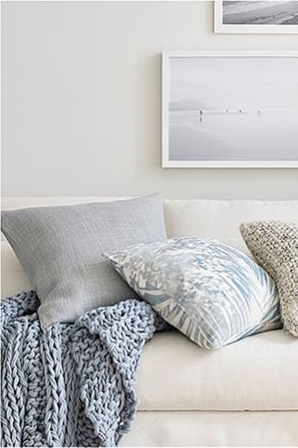 Beachy linen sofa with Pottery Barn blue gray linen pillows and chunky knit throw.