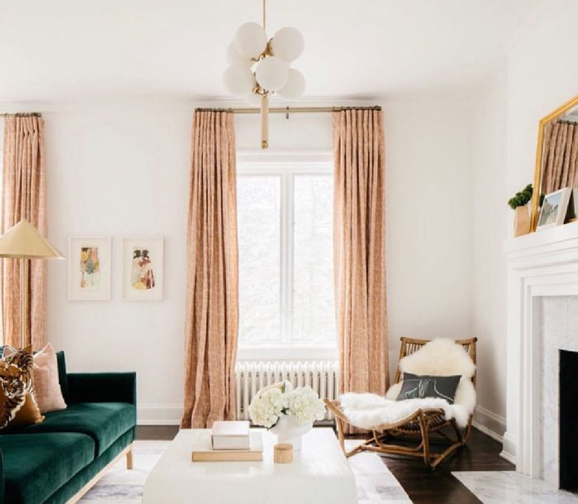 Pink drapes and green velvet sofa in a luxuriously chic living space by @jentalbotdesign. #interiordesign #pinkandgreen