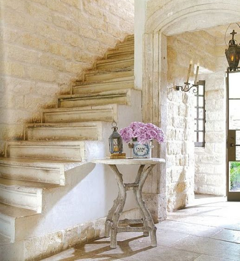 Stunning Old World style French country staircase with limestone (Chateau Domingue) and antiques from France. Ruth Gay's home in Houston! #frenchcountry #frenchstone #rusticelegance #staircase #oldworld