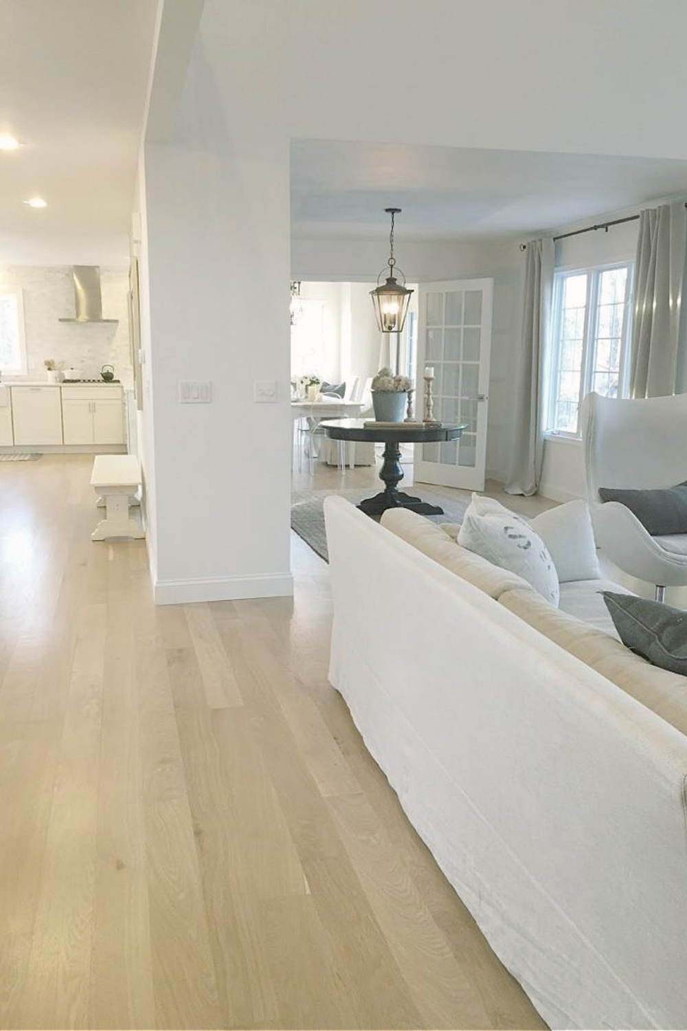 European country cottage open floor plan in our home with white oak, Belgian linen, and liberal doses of white decor - Hello Lovely.