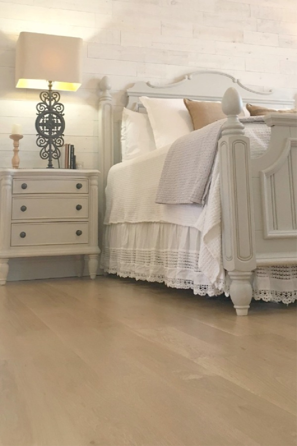 Serene neutral bedroom with white oak hardwoods, cottage style furniture, and white bedding - Hello Lovely Studio.