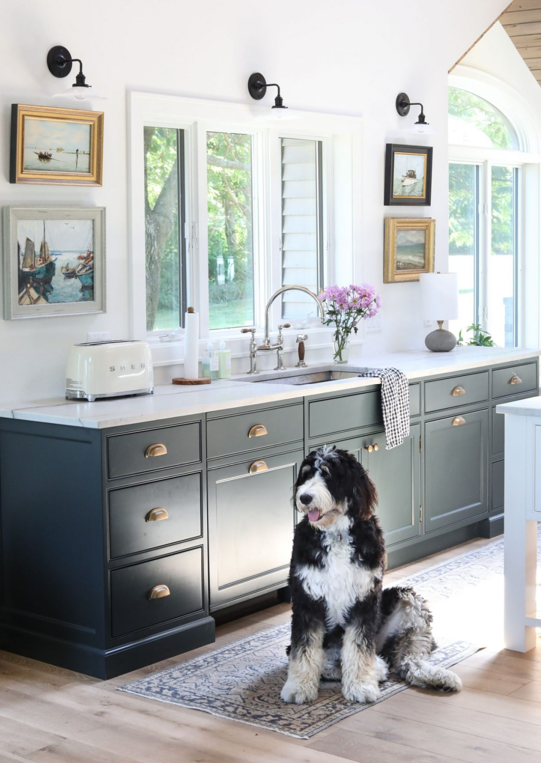 Sophisticated and elegant kitchen with dark gray cabinets and no uppers - instead framed art! Park & Oak Design. #greykitchens #darkgraycabinets #artinthekitchen