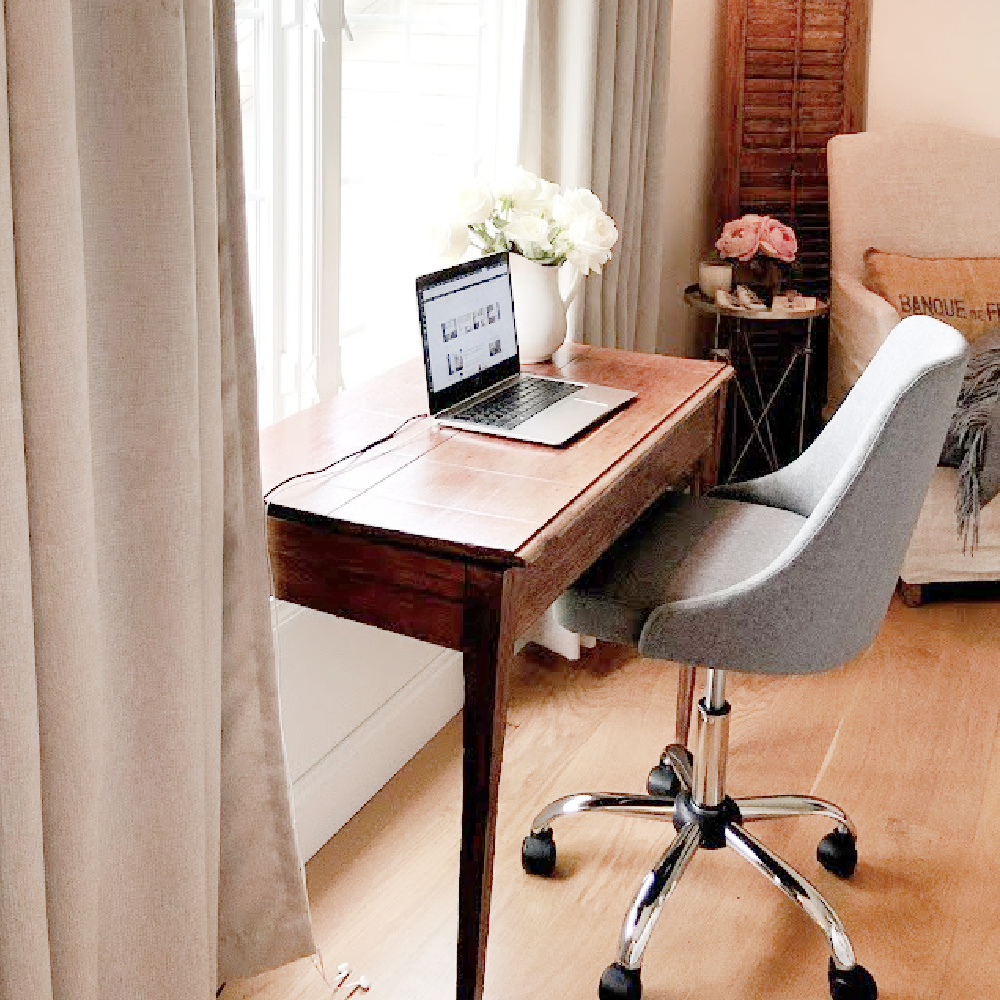 Home office with chic grey upholstered desk chair with antique desk in our French country bedroom - Hello Lovely.