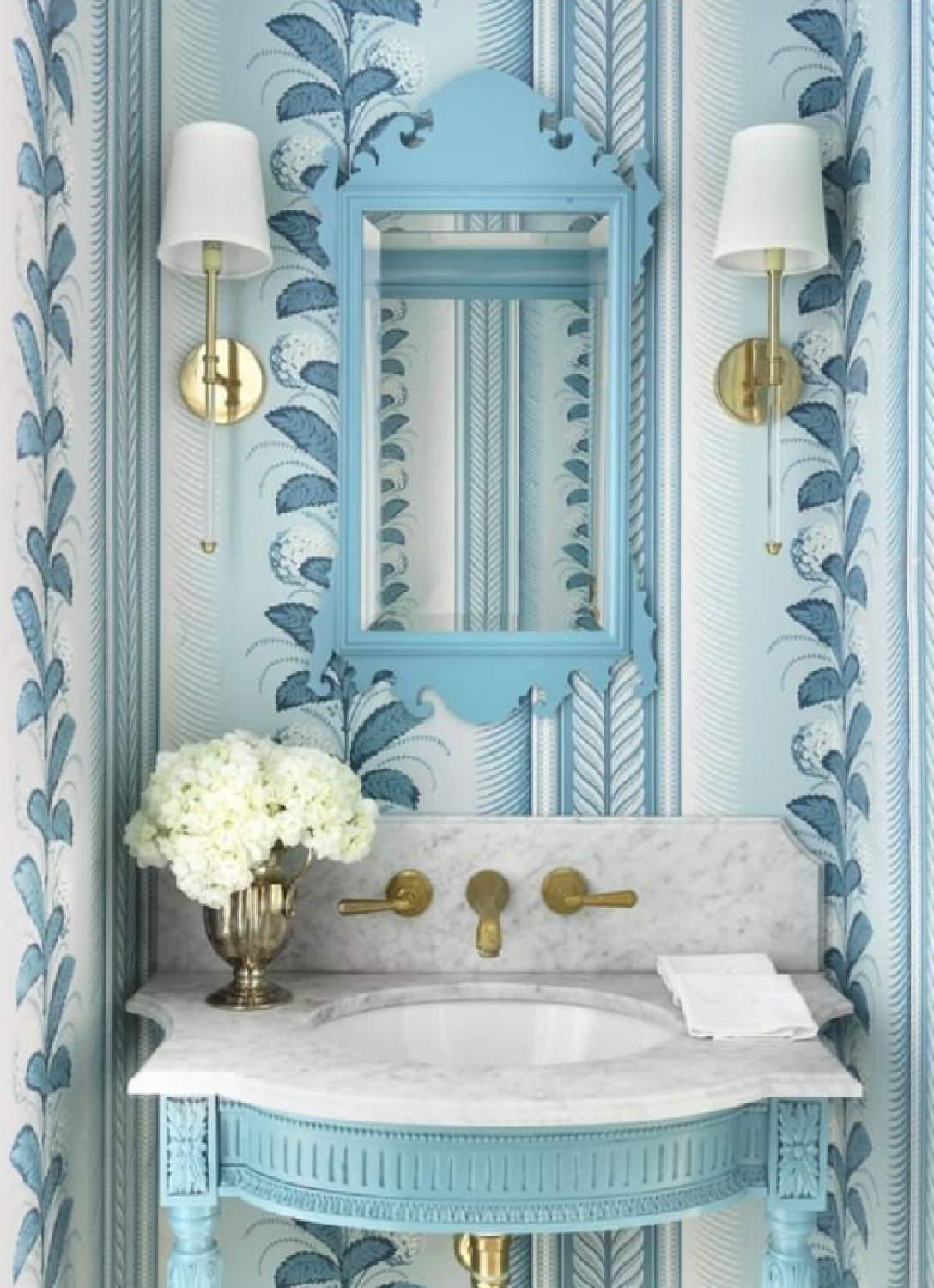 Schumacher Hydrangea Drape wallpaper in Delft in a cheerful blue classic powder bathroom by @amystudebakerdesign. #bluebathroom #bluewallpaper #bathroomwallpaper