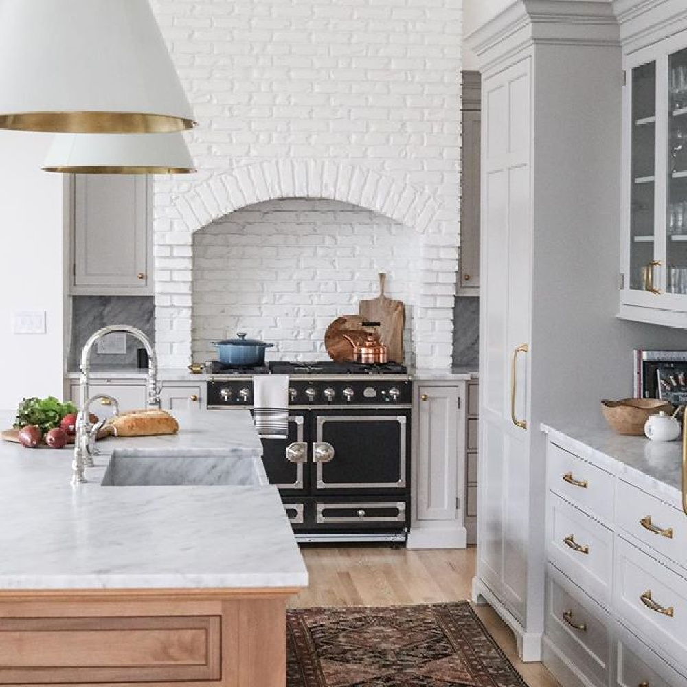 White brick and custom arched range hood in a classic kitchen by Park & Oak. #whitebrick #classickitchendesign #traditionalkitchens