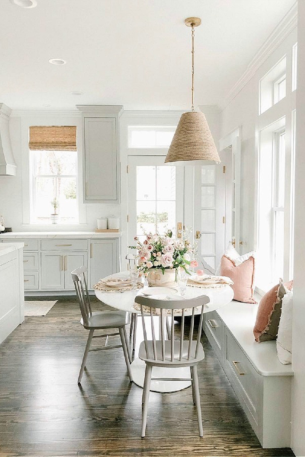 Timeless and classic grey and white kitchen by Finding Lovely with its window seat breakfast nook and pink accents!