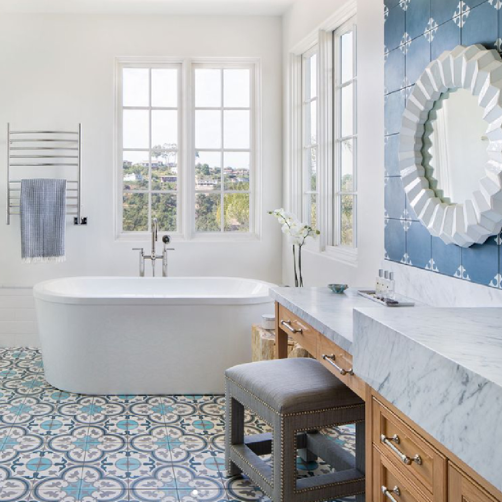 Beautiful blue and white tiled bathroom with soaking tub - Jessica Risko Smith. #bluebathrooms #bluefloortile