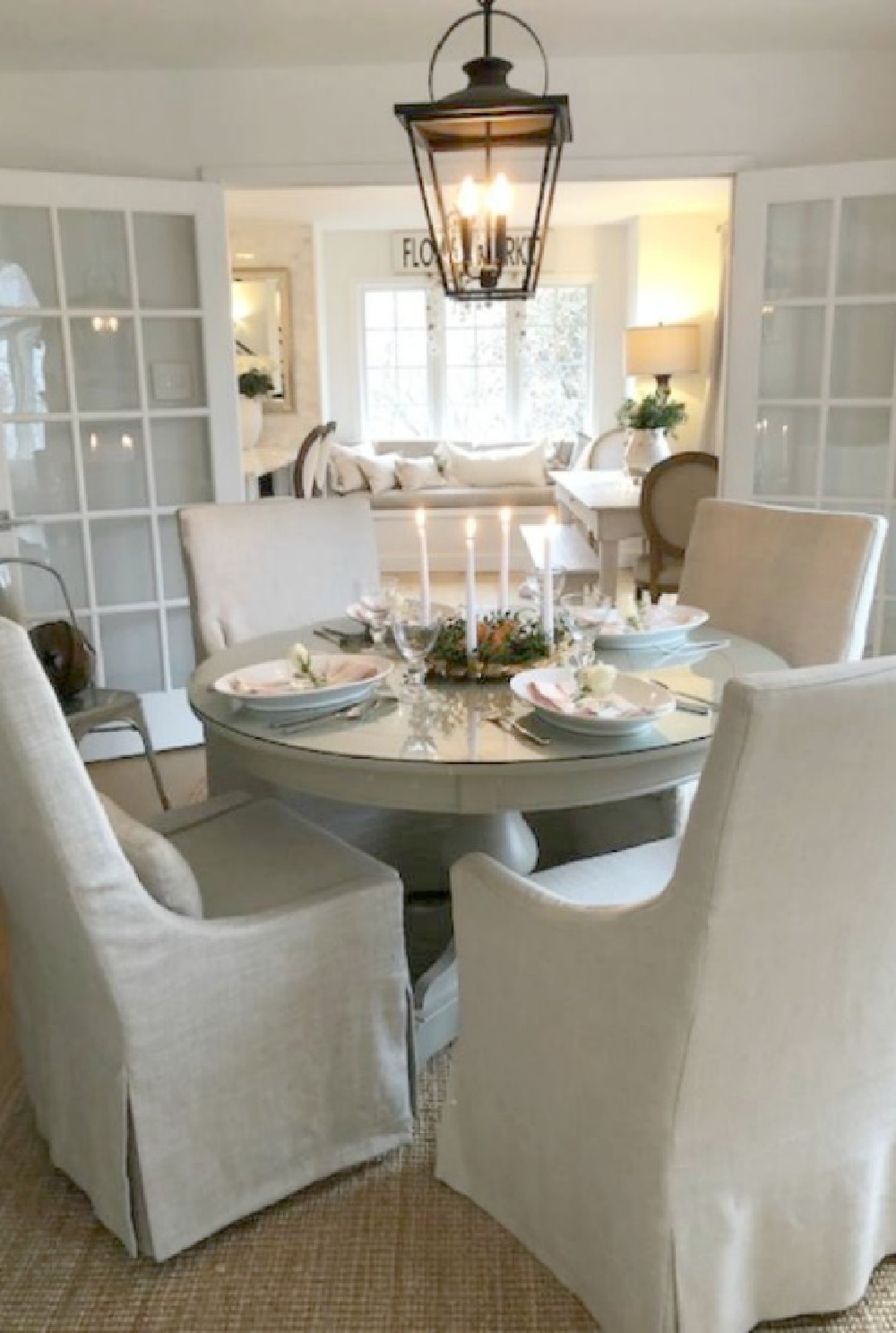 Belgian linen arm chairs around my round dining table - Hello Lovely Studio.