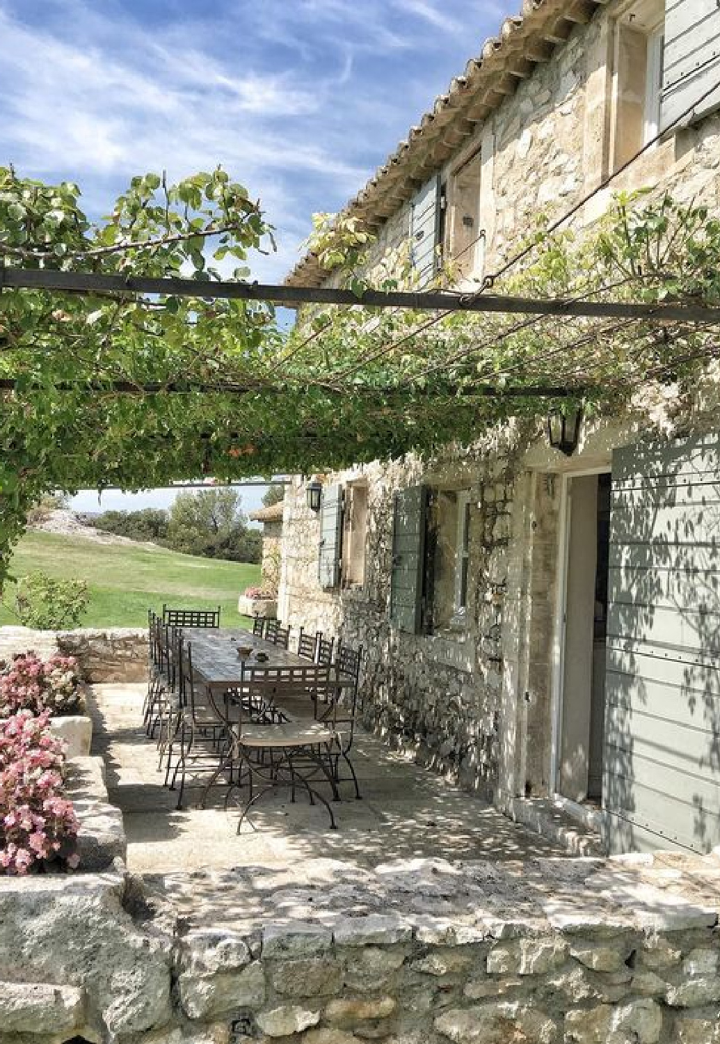 Rustic elegant stone French farmhouse pergola and exterior with shutters - Vivi et Margot. #frenchfarmhouse #houseexteriors #rusticfarmhouse