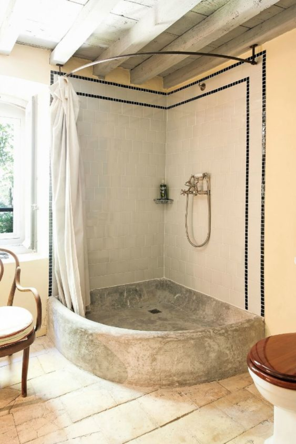 Old world style shower in a bathroom in a French chateau - Haven In. #stoneshower #bathroomdesign #oldworldstyle