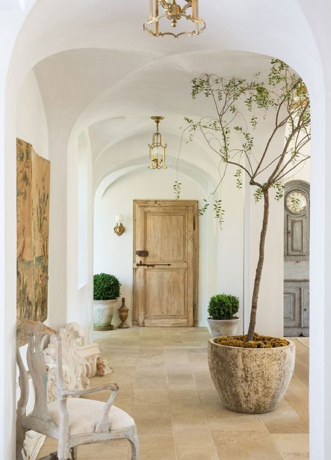 Limestone flooring, antique wood doors, groin vault ceilings, plaster walls, Swedish antiques and French farmhouse allure in Brooke Giannetti's Patina Farm home - Velvet & Linen. #patinafarm #frenchfarmhouse #limestonefloors