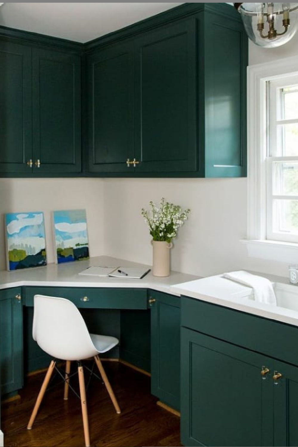 Green kitchen cabinets painted BM Tarrytown Green with white walls and MCM desk chair. #tarrytowngreen #paintcolors #greenkitchen