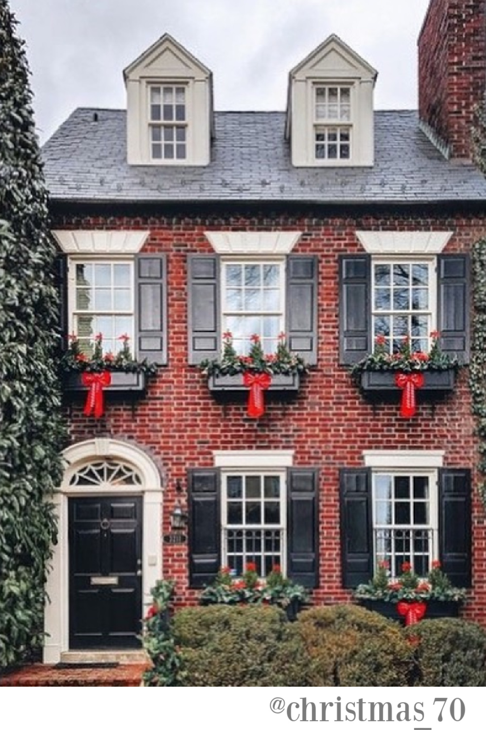 Traditional red brick house exterior decorated with window boxes for holidays - @christmas_70. #christmasdecor #houseexteriors #outdoorchristmasdecor